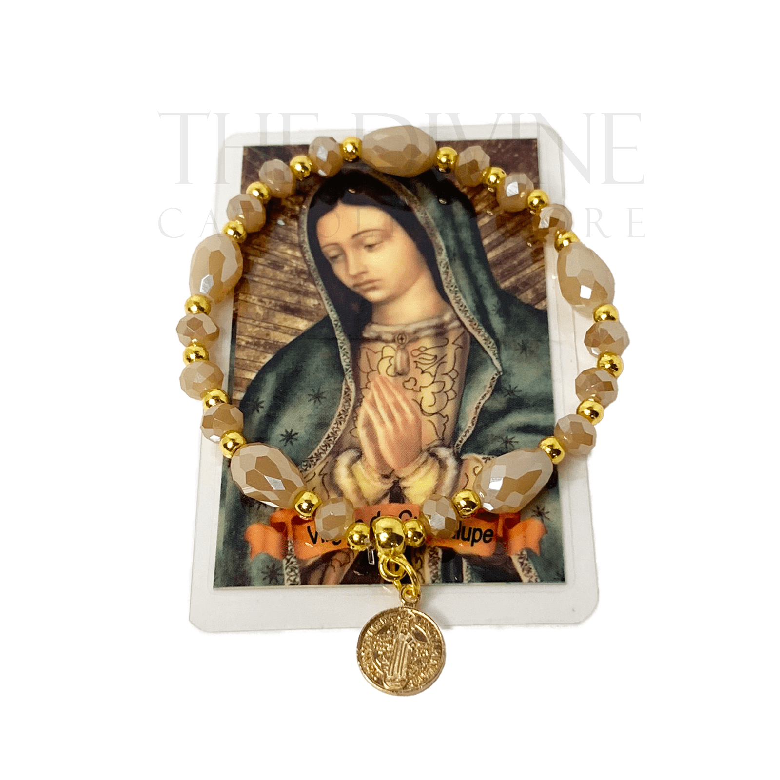 Beige and gold beaded St. Benedict bracelet with elastic band, shown with Spanish Our Lady of Guadalupe prayer card on white background. 
