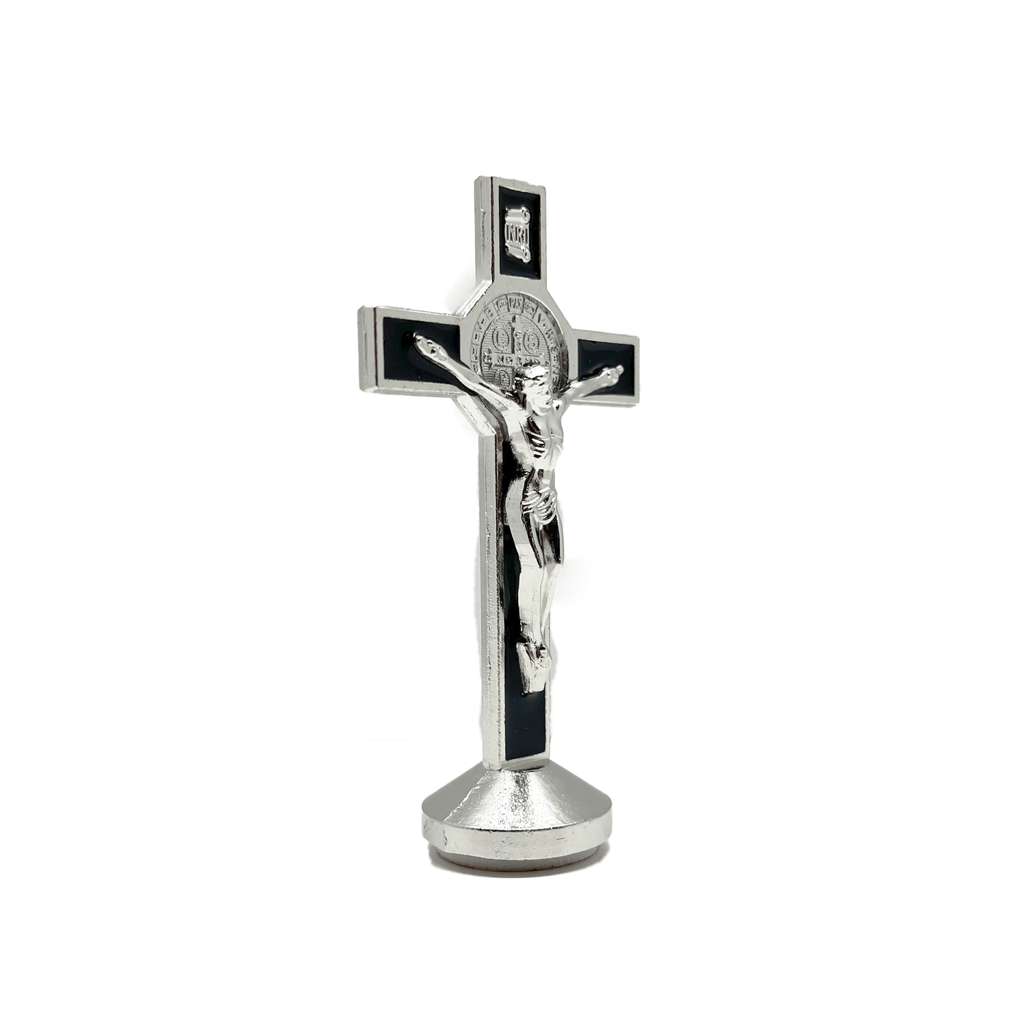 This 3 inch dashboard St. Benedict crucifix is black with a silver St.Benedict medal behind a silver corpus, silver-tone detailing and sturdy base with adhesive at bottom, side view.