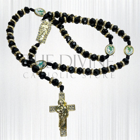 Crystal St. Jude rosary in black has a St. Benedict crucifix pendant, St. Jude charm pendant in middle, and around rosary, silver rhinestone beads throughout, and silver charms on a white background.