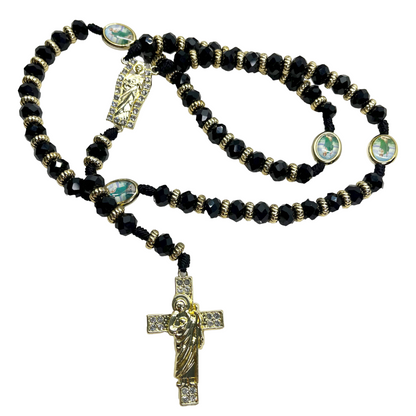 Black beaded St. Jude rosary with gold crucifix and centerpiece on black nylon cord on white background, 