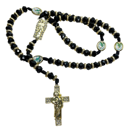 Black beaded St. Jude rosary with gold crucifix and centerpiece on black nylon cord on white background, 