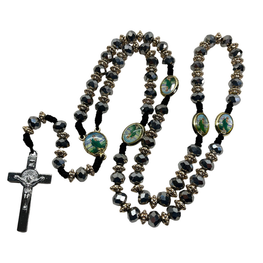 Silver beaded St. Jude rosary with St. Benedict crucifix on black nylon cord on a white background,. 