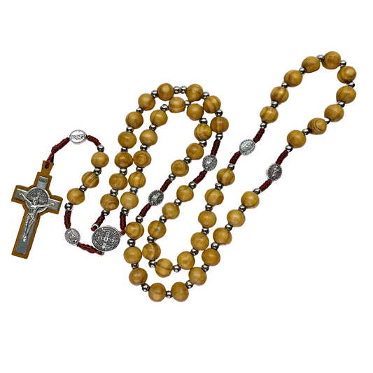 Handmade beige wooden rosary with St. Jude pater beads and St. Benedict centerpiece on a white background. 