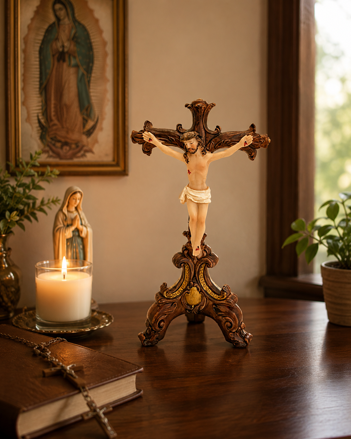 Traditional tabletop crucifix displayed on home altar with candle, rosary, Bible, Virgin Mary statue, and Our Lady of Guadalupe painting in background