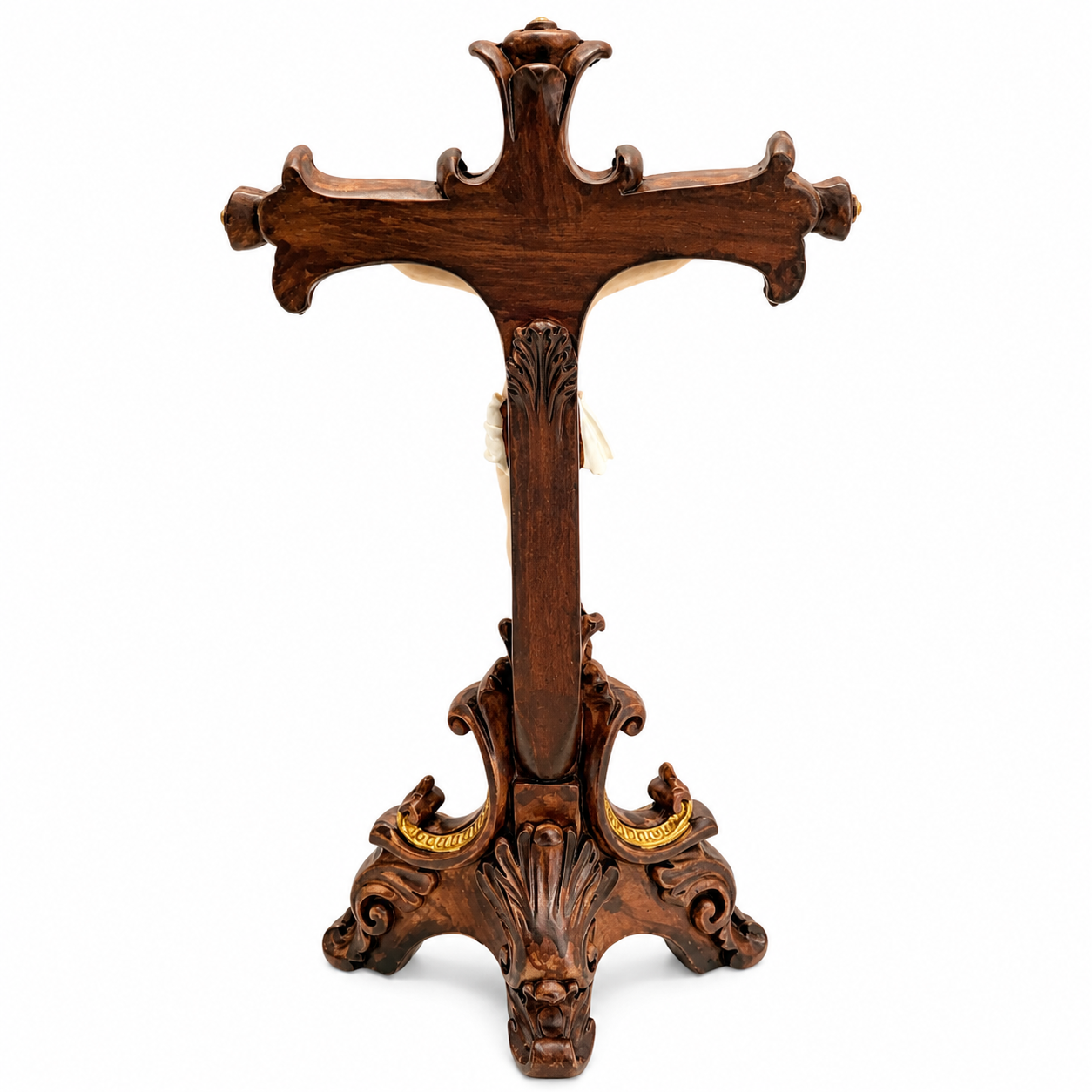 Back view of traditional tabletop standing crucifix showing ornate dark walnut resin cross with scrollwork details and gold accent tripod base