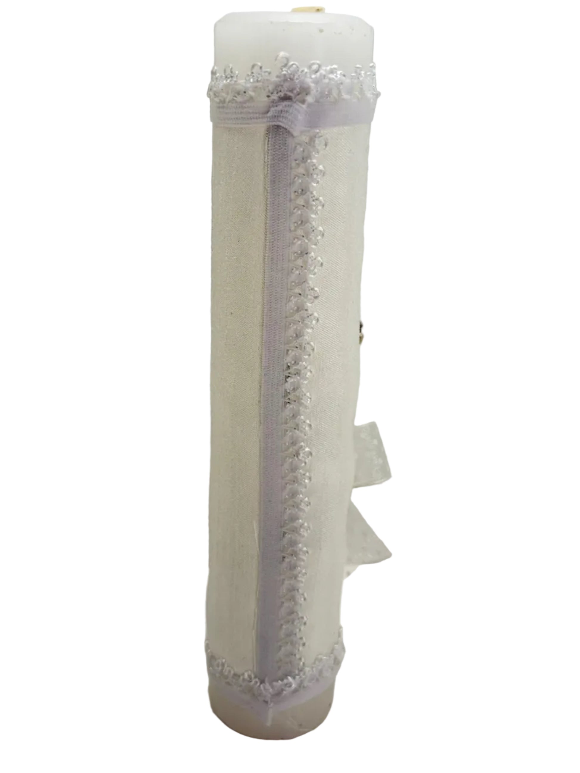 	Side view of white fabric wrapped baptism candle with decorative trim